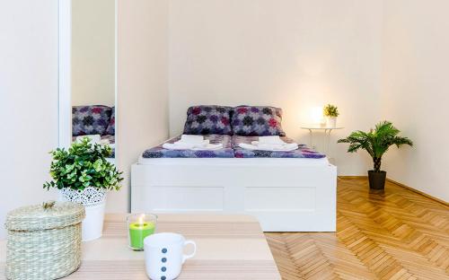 a room with a bed and a coffee table at Cozy 2 Bedroom Apartment In Terez Boulevard. in Budapest