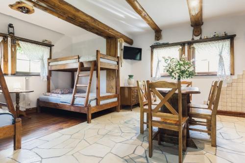 a room with bunk beds and a table and chairs at Noclegi Na Czakowie in Wołkowyja
