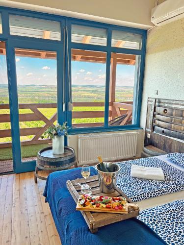 a room with a table with a tray of food on it at Hilltop Borbirtok & Étterem in Neszmély