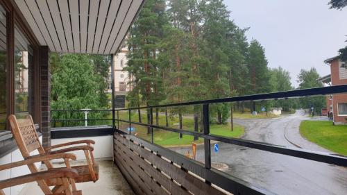 a balcony with a chair and a view of a street at Gracia's Kitchen & Inn in Valtimo
