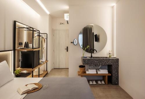 a bedroom with a fireplace and a mirror at Chora Suites, Premium Key Collection in Skiathos Town