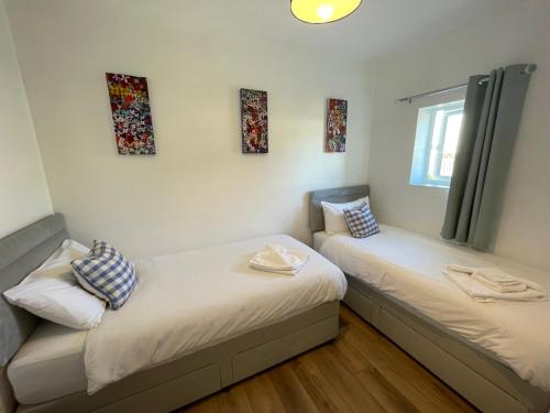 two twin beds in a room with windows at Driftwood Seagrass in Par