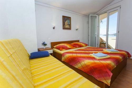 a bedroom with two beds and a window at Apartments by the sea Drasnice, Makarska - 6697 in Drasnice