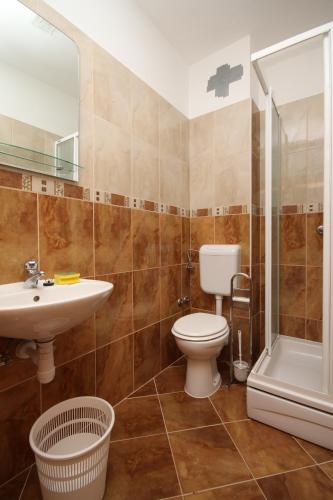a bathroom with a toilet and a sink and a shower at Rooms by the sea Metajna, Pag - 6487 in Metajna