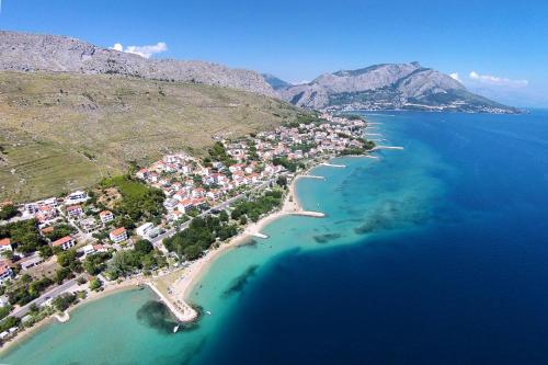 an aerial view of a small island in the ocean at Apartments and rooms by the sea Duce, Omis - 2746 in Duće