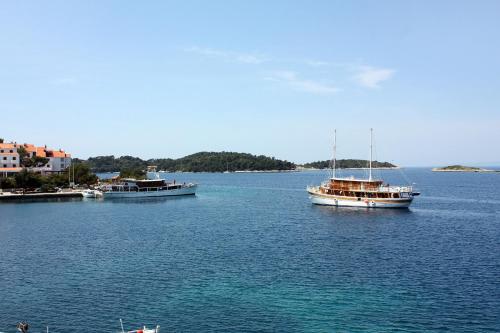 two boats floating in a large body of water at Rooms by the sea Pomena, Mljet - 4929 in Pomena
