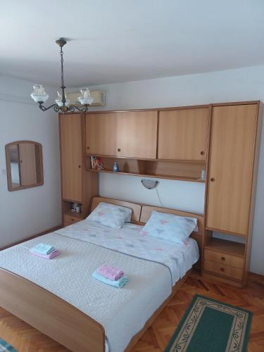 a bedroom with a bed with two towels on it at Rooms by the sea Pomena, Mljet - 4929 in Pomena
