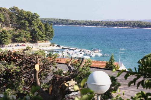 a view of the ocean from a resort at Apartments and rooms by the sea Banjol, Rab - 5077 in Rab