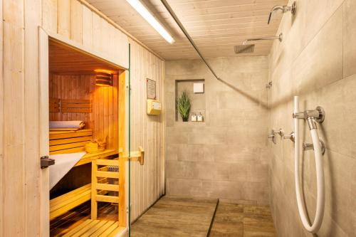 ein Bad mit einer Dusche und einer ebenerdigen Dusche in der Unterkunft Hotel Tannhof in Oberstdorf