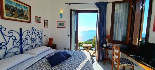a bedroom with a bed and a window with a view at Guest House Villa Il Gabbiano in Ponza