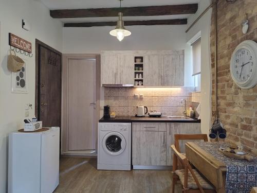 a kitchen with a washer and dryer in a room at Casa Collage in Corfu Town