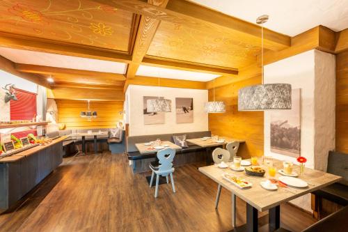 a dining room with wooden walls and wooden floors at Hotel Tannhof in Oberstdorf