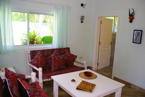 a living room with a couch and a table at Princess of Zanzibar in Michamvi