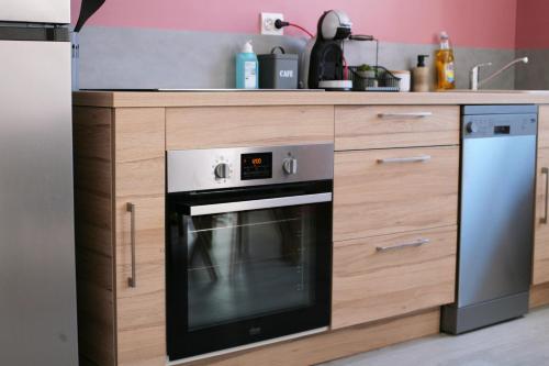 a kitchen with a stove and a sink at Rully house in Rully