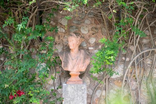 a statue of a bust in front of a wall at Ca'n Puig de Sòller in Sóller