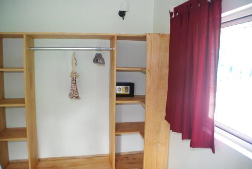a room with a book shelf next to a window at Princess of Zanzibar in Michamvi