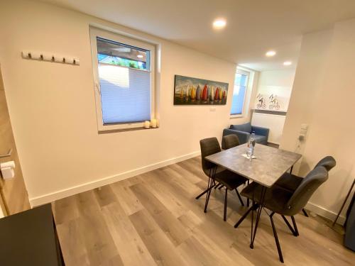 a dining room with a table and chairs and a window at Haus am Iberg 4 in Willingen