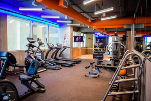 a gym with several treadmills and cardio machines at Saraya Corniche Hotel in Doha