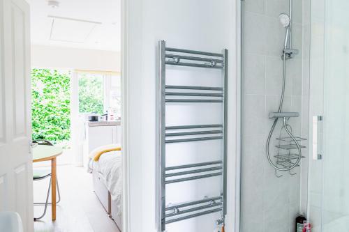 a bathroom with a glass shower door at Double Ensuite in Central Forest Row in Forest Row