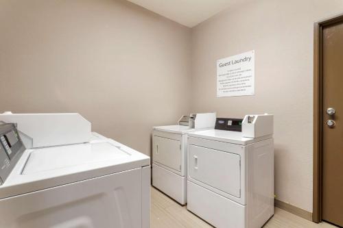 a laundry room with a washer and dryer at Comfort Suites Kingwood Humble Houston North in Humble