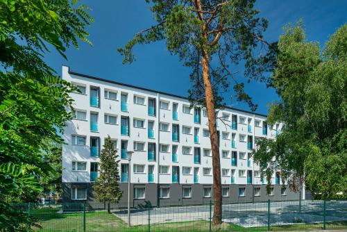 a white building with blue windows at Halo Hel in Hel
