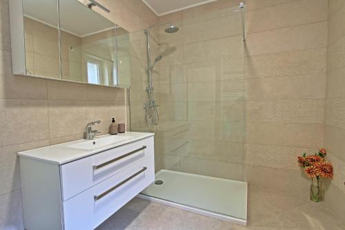 a bathroom with a white sink and a shower at Apartman F&F 2 in Otočac