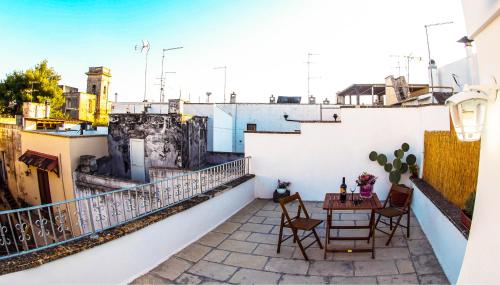 a balcony with a table and chairs on a building at B&B a Casa della Nonna Uccia in Nardò