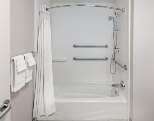 a bathroom with a shower and a white tub at Holiday Inn Express & Suites Baton Rouge East, an IHG Hotel in Baton Rouge