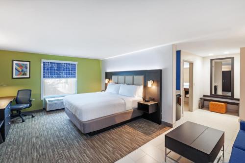 a hotel room with a bed and a desk at Holiday Inn Express & Suites Baton Rouge East by IHG in Baton Rouge