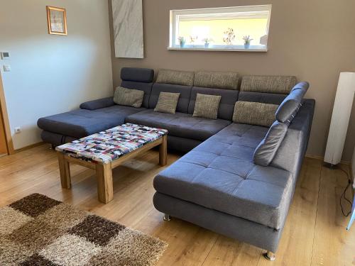 a living room with a couch and a coffee table at Reiger Ferienwohnungen in Wackersdorf