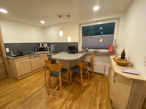 a kitchen with a table and chairs in a kitchen at Haus am Iberg 4 in Willingen