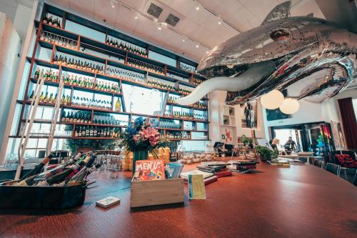 a restaurant with a shark hanging from the ceiling at Hotel AX in Helsinki