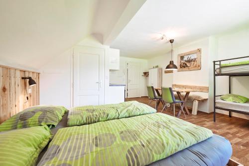 a bedroom with two beds and a table with chairs at Gesäuse-Lodge in Gstatterboden