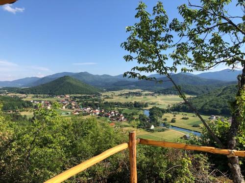 a view of a valley with a town and mountains at Apartman F&F 2 in Otočac