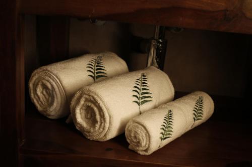 a group of four rolls of paper towels on a shelf at The Fern Seaside Luxurious Tent Resort Diu in Diu