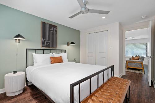 a bedroom with a large bed and a ceiling fan at Abode Houston - Norfolk in Houston