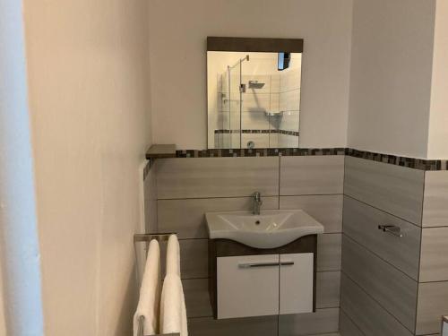 ein Bad mit einem Waschbecken und einem Spiegel in der Unterkunft Lovely 1 Bedroom Unit in an Amazing Golf Estate in Roodepoort
