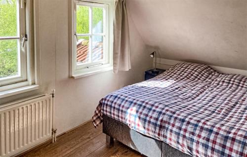 een slaapkamer met een bed en 2 ramen bij Buitengoed Het Lageveld- 68 in Hoge-Hexel