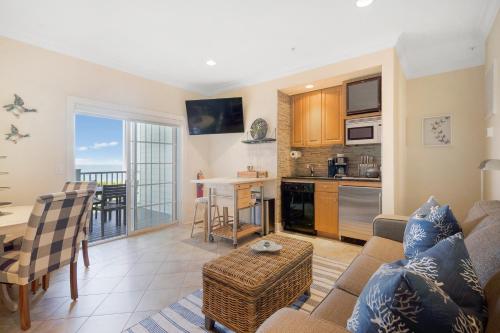 a living room with a couch and a table and a kitchen at The Cliffside Resort Condominiums in Greenport