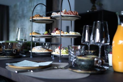 a table topped with plates of food on tiers at Luxury Apart Sailers including Premium Summercard in Sankt Anton am Arlberg
