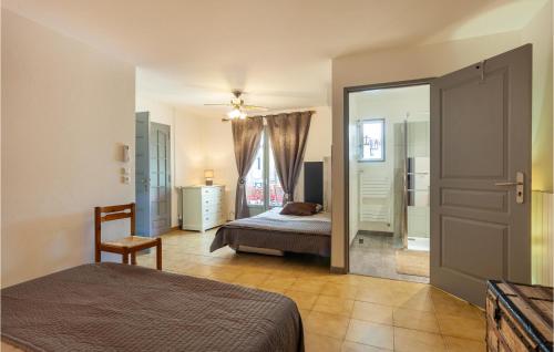 a bedroom with a bed and a dresser and a mirror at Amazing Home In Signes With Wifi, Heated Swimming Pool And Swimming Pool in Signes