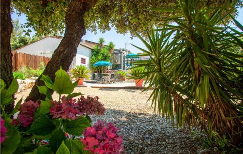 a garden with trees and flowers in a yard at Beautiful Home In Signes in Signes