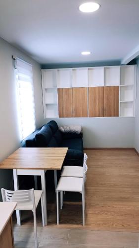 a living room with a couch and a table at Precioso estudio en Cedeira. in Cedeira