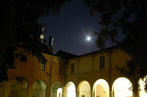 a large building with a moon in the sky at Il Chiostro Hostel and Hotel in Alessandria