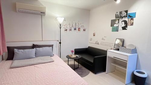 a bedroom with a bed and a chair and a desk at Ellen House in Seoul
