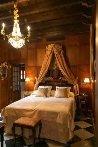 a bedroom with a large bed with a canopy at Hotel Ateneo Sevilla in Seville
