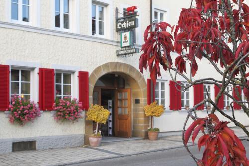 a building with red shutters on a street at Hotel-Restaurant Roter Ochsen in Lauchheim