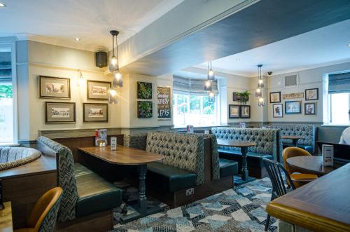 a restaurant with tables and chairs and a bar at Fox Inn in Guisborough