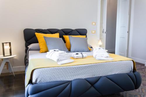 a large blue bed with towels on top of it at Dimora Cavour in Amantea