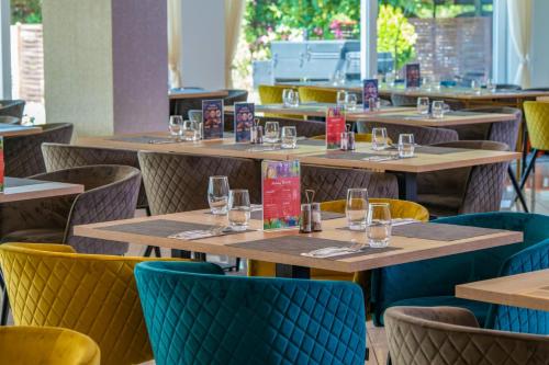 a row of tables and chairs in a restaurant at Holiday Resorts in Balatonszárszó